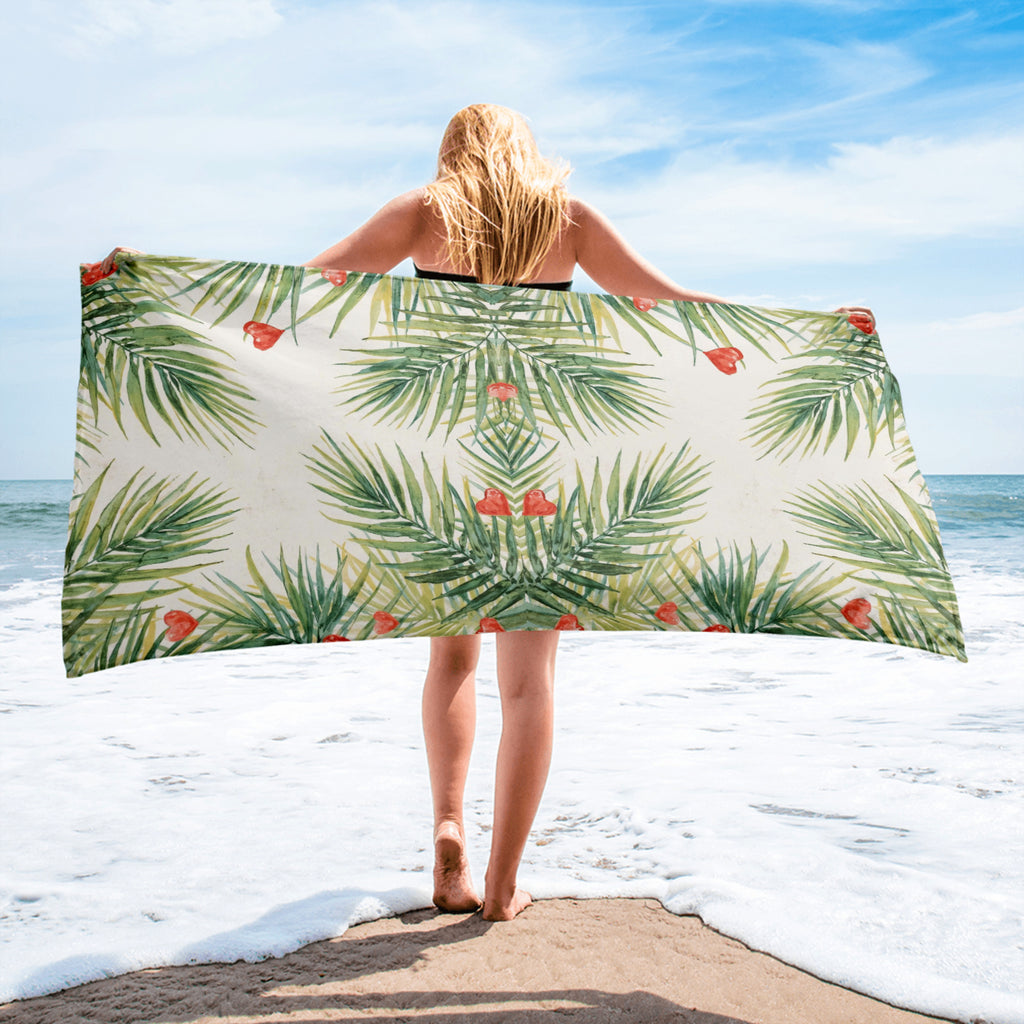 Tropical beach towel with palm leaves and red hearts pattern