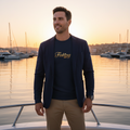 Man navy blazer fishing sweatshirt gold text fishing boat sunrise coastal harbor nautical