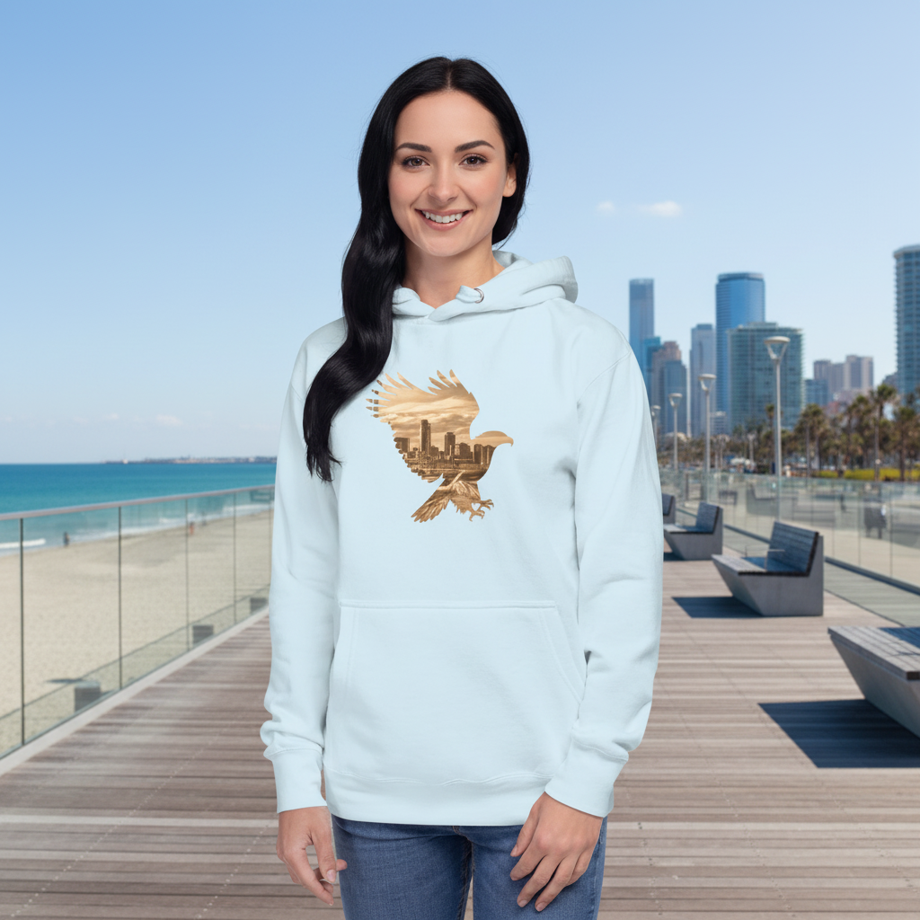 Elegant woman wearing sky blue hoodie with eagle city silhouette at coastal waterfront - sophisticated beach casual style
